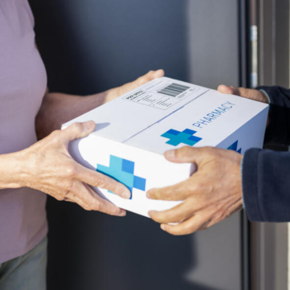 A woman taking prescription delivery from her door